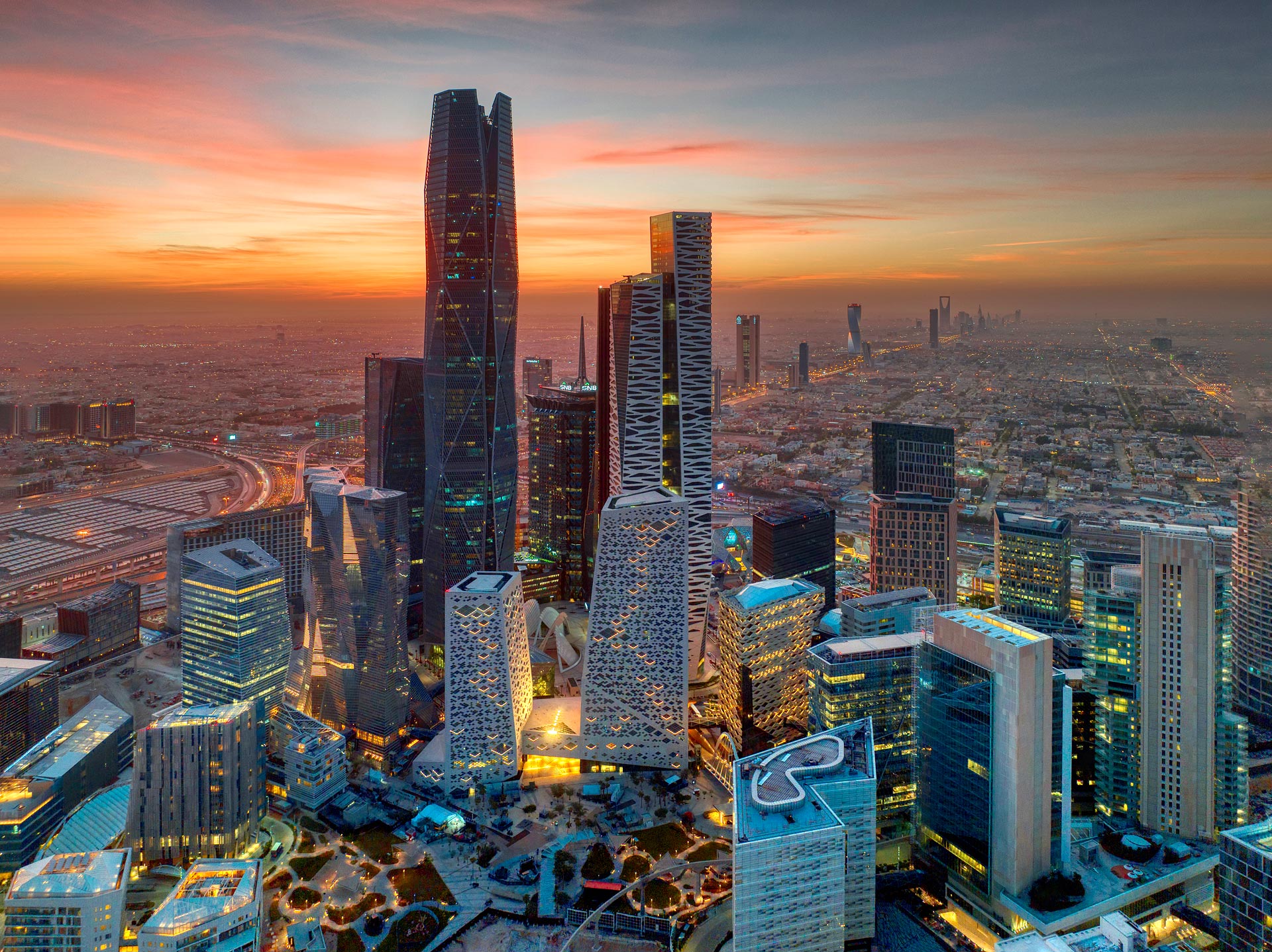 Futuristic isometric Saudi smart city skyline with glowing teal data lines